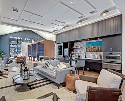 A modern living room with a grey couch and a coffee table.