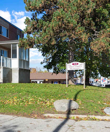 a large brick building with a sign in front of it