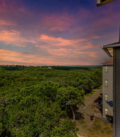 a view of the forest from the top of the house at sunset at The Verandah, Austin, Texas