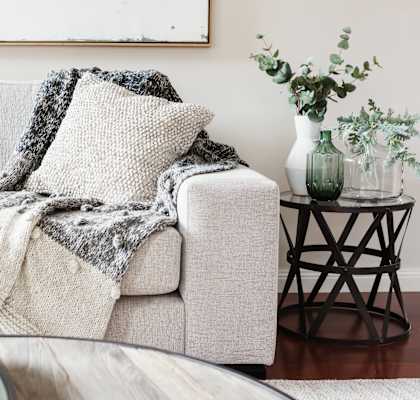 a living room with a couch and a blanket on it