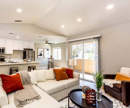 A modern living room with a white couch and a coffee table.