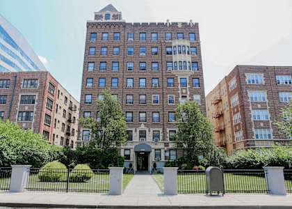 a large brick building with trees in front of it