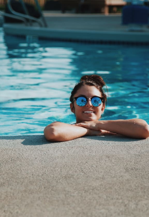 person enjoying pool Meridian Place Apartments in CA 91324