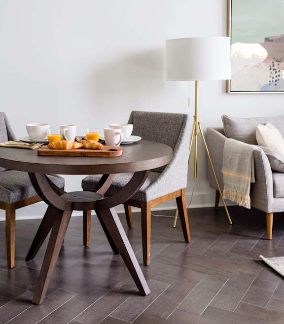 A modern dining room with a round table and chairs at The Pennsylvanian Apartments, Pittsburgh, Pennsylvania