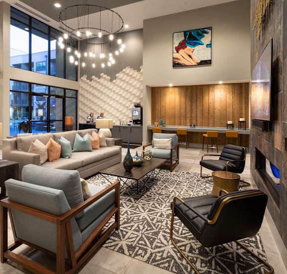 a living room with couches and chairs and a fireplace