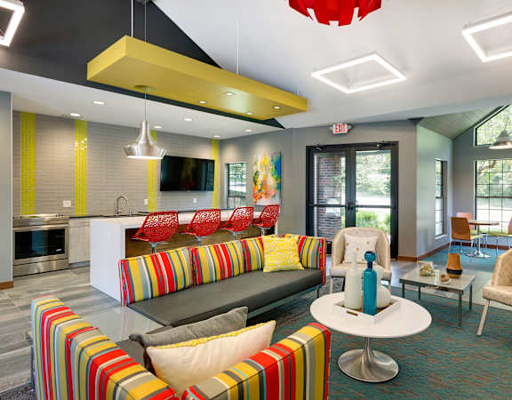 A modern living room with a striped couch and a coffee table.