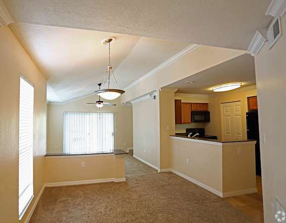 an empty living room with a kitchen in the background at  Bridgewater Apartments , Florida 33716