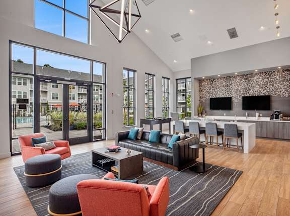 A modern living room with a large window and a bar area.
