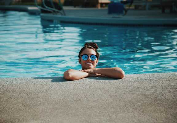 a girl with sunglasses in a swimming pool
