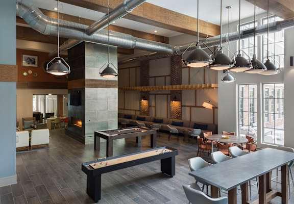 A modern dining room with a long table and chairs.