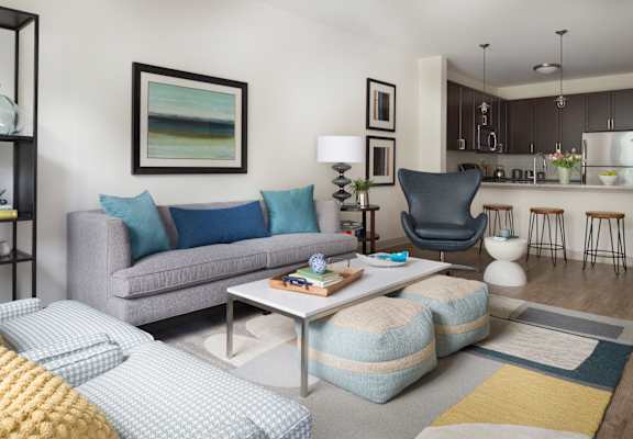 A modern living room with a grey couch and a coffee table.