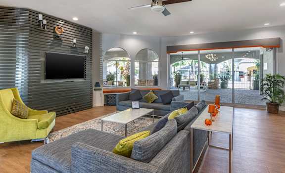 a living room filled with furniture and a flat screen tv at Boulders at Lookout Mountain Apartment Homes, Arizona, 85022