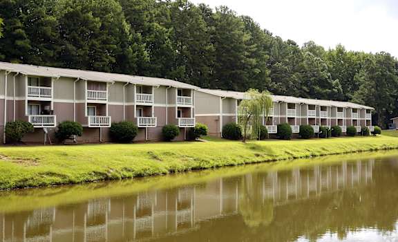 a row of apartment buildings next to a body of water