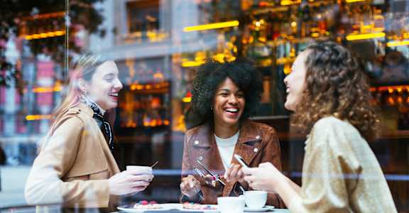 three women sitting at a table in a restaurant