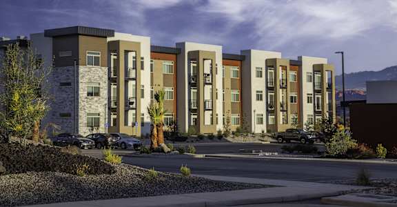 an exterior view of an apartment building on a city street