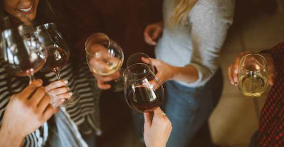 a group of people holding wine glasses