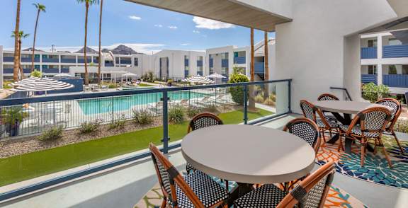 A hot tub sits in the middle of a pool surrounded by chairs.