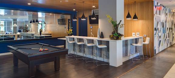 a room with a pool table and a bar