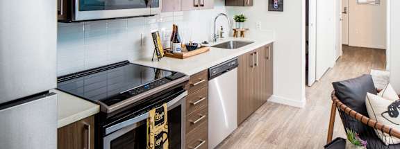 a kitchen with a stove and a sink and a microwave
