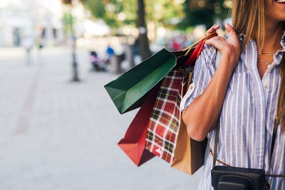 A woman is holding shopping bags in her hands. at Penn Circle, Carmel, Indiana