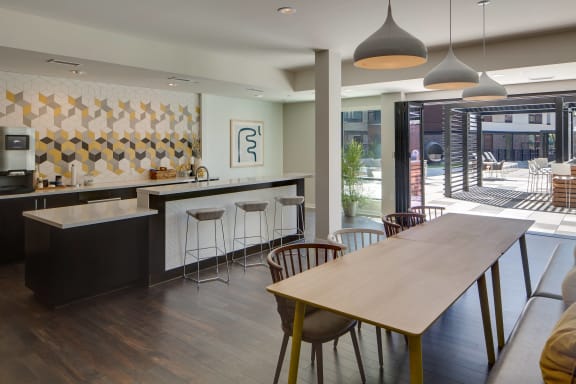 a kitchen and dining area with a wooden table and chairs
