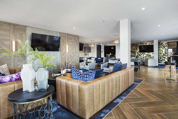 a living room filled with furniture and a large tv