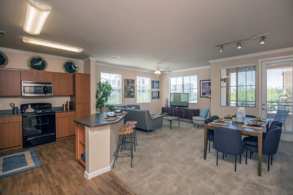 an open living room and kitchen with a dining room table and chairs at Loreto & Palacio Apartments, Las Vegas