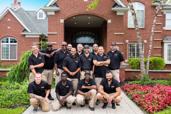 a group of people standing in front of a house