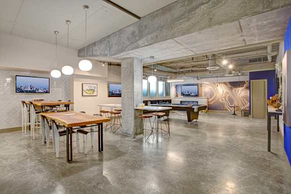 a dining room with tables and chairs and a pool table