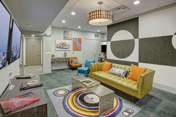 a living room with a yellow couch and a coffee table