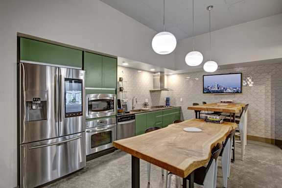 a kitchen with stainless steel appliances and a wooden table