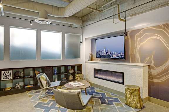 a living room with a fireplace and a television