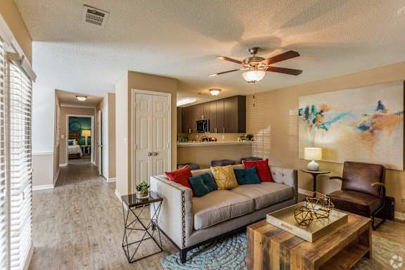a dining room with a table and chairs and a painting on the wall  at Quail Ridge Apartment Homes, Bartlett, 38135