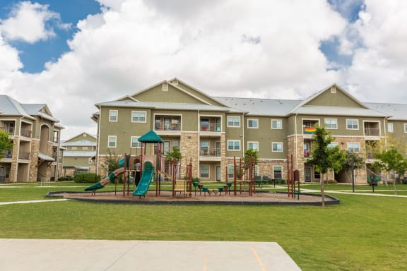 a large apartment building with trees in front of it