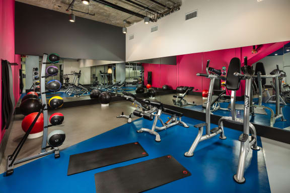 Fitness center with yoga mat and weight balls at Topaz Apartments, California, 90013