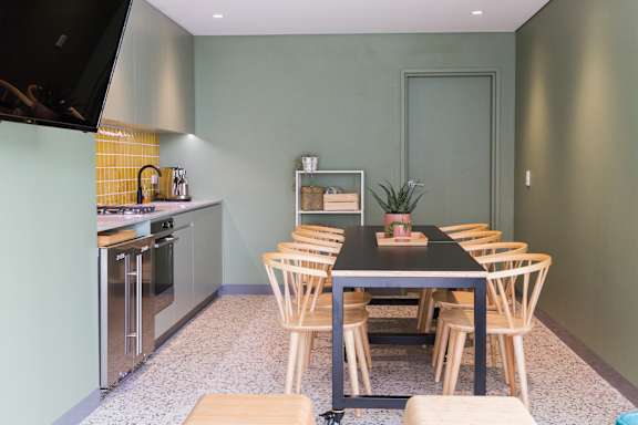 a dining room with a table and chairs and a kitchen
