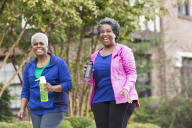 two women walking in the park