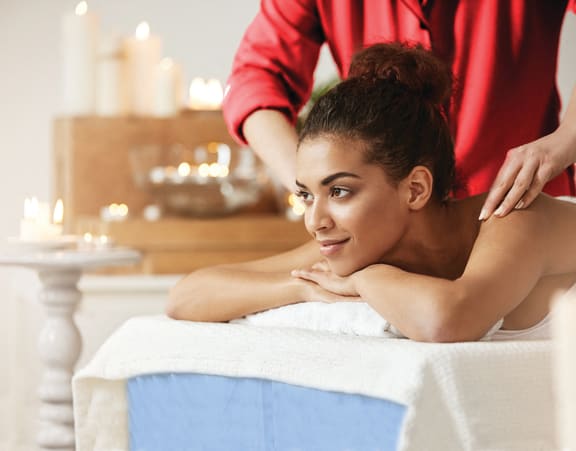 a woman getting a massage at a spa at Altis Twin Lakes Apartments, Kissimmee, FL 34744