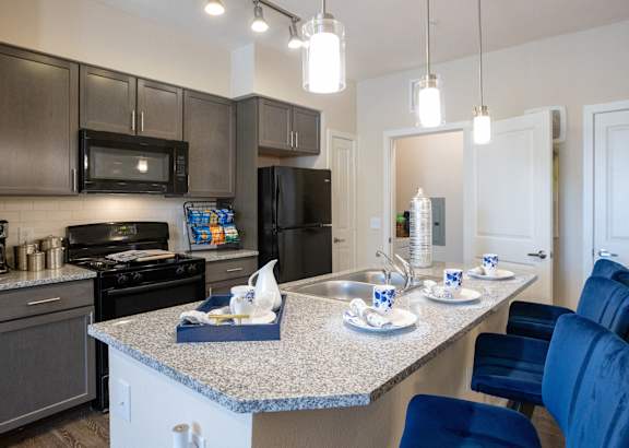 a kitchen with white cabinets and a granite counter top