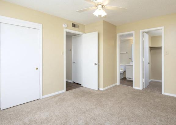 a living room filled with furniture and a ceiling fan