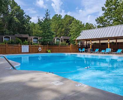 a swimming pool with chairs and a resort style pool