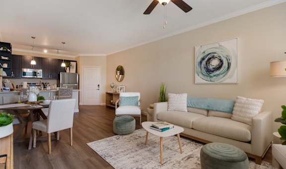 a living room with a ceiling fan and hardwood floors