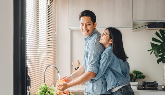 Loving couple washing vegetables at Whitney Gray, Oregon, 97205