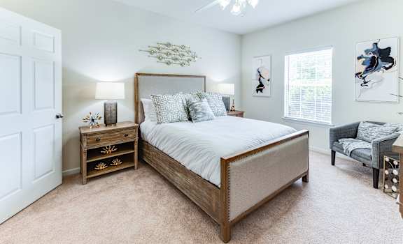 a bedroom with a large bed and a ceiling fan