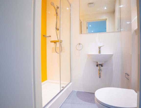 a small bathroom with a toilet sink and shower