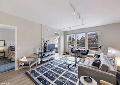 a living room with a blue and white rug and a couch