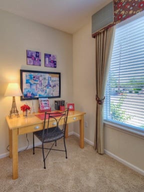 Vue Park West Desk space with large window and wall to wall carpet