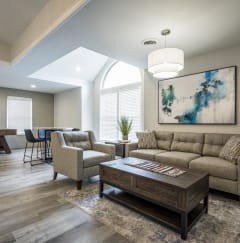 a living room filled with furniture and a large window