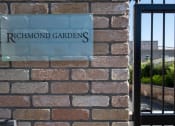 Thumbnail 1 of 7 - a sign that reads richmond gardens on a brick wall