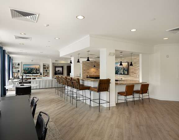 A modern dining room with a long table and chairs.